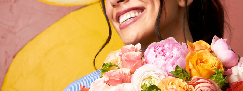Close up of a woman holding a bouquet in preparation for Easter brunch.
