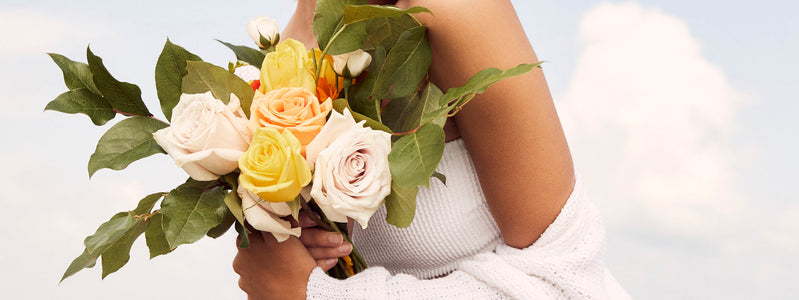 Woman carrying a yellow flower bouquet