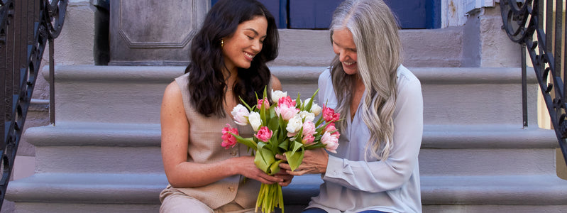 Woman gifting her mom Mother's Day flowers from UrbanStems.