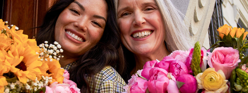 Girl and he rmother celebrating Mothers Day 2022 with flowers for Mother's Day