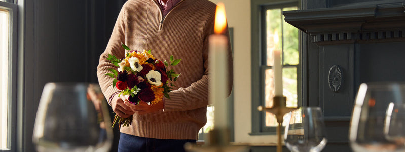 Man holding a bouquet of mum flowers for entertaining