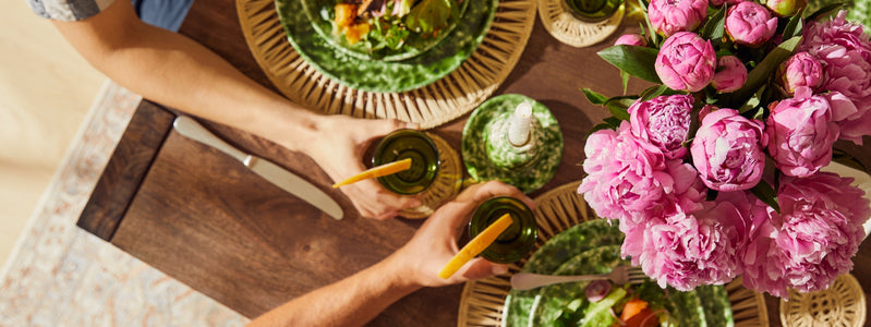 Bouquet of pink peonies on dining table.