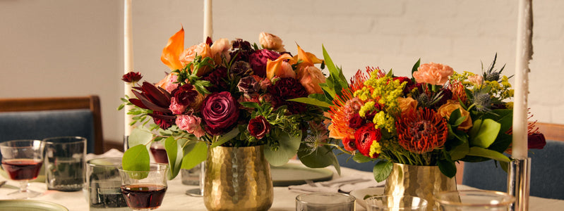 Close up of two colorful fall centerpieces by UrbanStems