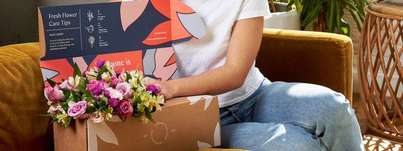 Woman sending herself UrbanStems flowers for self-love