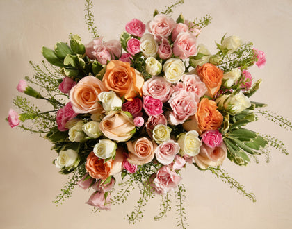 Bouquet of colorful roses on a beige background