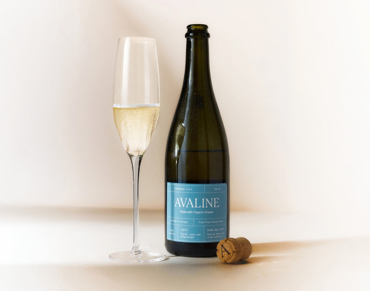 Bottle of Avaline wine with a glass of white wine on a light background