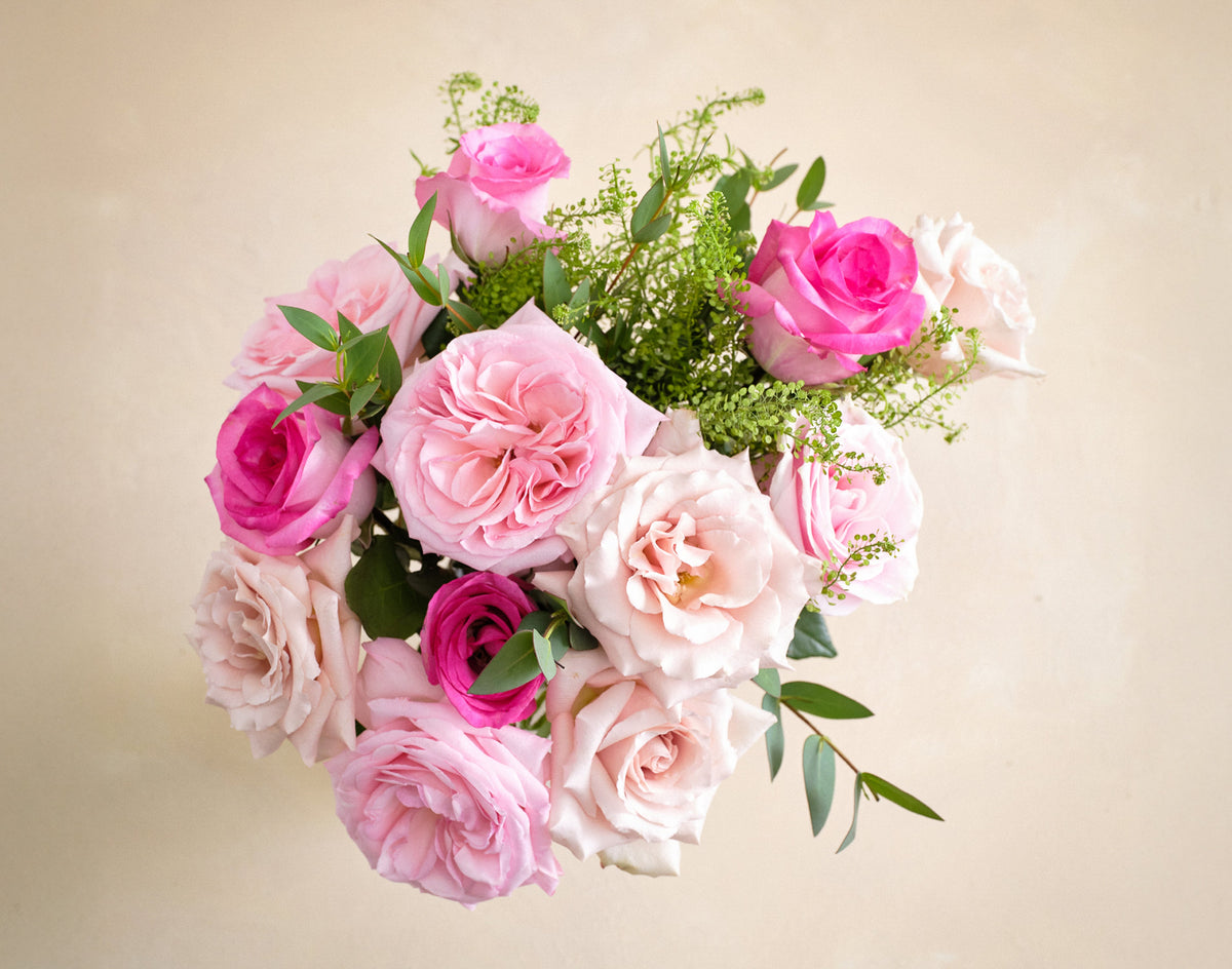 Bouquet of pink and green flowers on a beige background